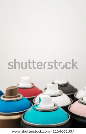 Spray paint dispenser in different colors: pink, white, blue, brown, red. White background