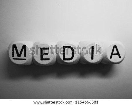 word media spelled on dice