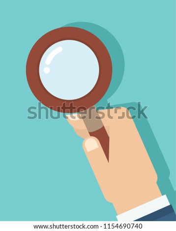 A businessman use 
magnifying glass to read the paper