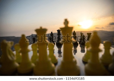 chess board game concept of business ideas and competition and strategy ideas. Chess figures on a chessboard outdoor sunset background. Selective focus