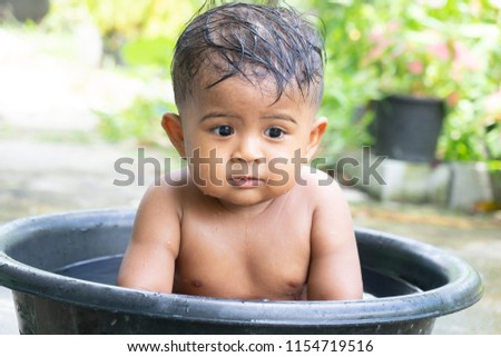 Cute little asian baby boy take a bath