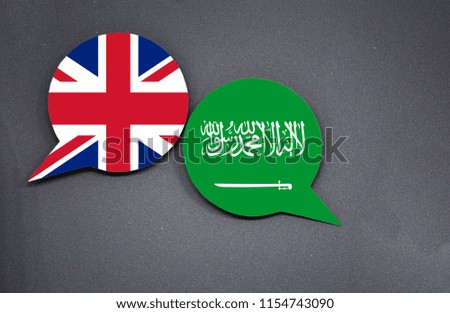 United Kingdom and Saudi Arabia flags with two speech bubbles on dark gray background