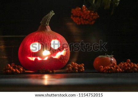 Halloween luminous pumpkin Jack-o-lanterns on the dark wooden background