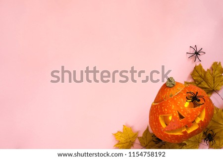 Halloween pumpkin head jack lantern frame with burning candles isolated on orange, flat lay with copy space