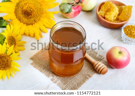 Honey in a glass jar, honeycomb, pollen. Products of beekeeping. The concept of healthy eating. Honey theme.
