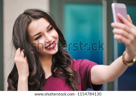 Young hipster woman, making selfie, funny face, posing at countryside at summer day.