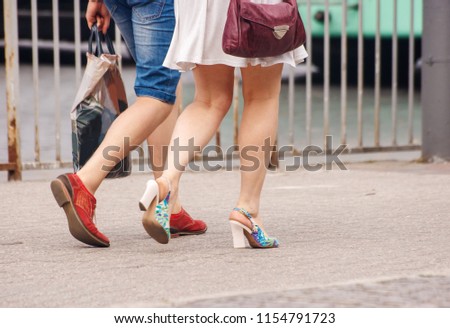 young couple walking in the city on sunny summer day