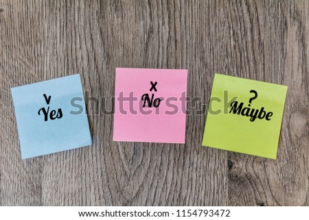 Colorful Sticky Notes with Yes,No and Maybe words  on a  Wooden Background