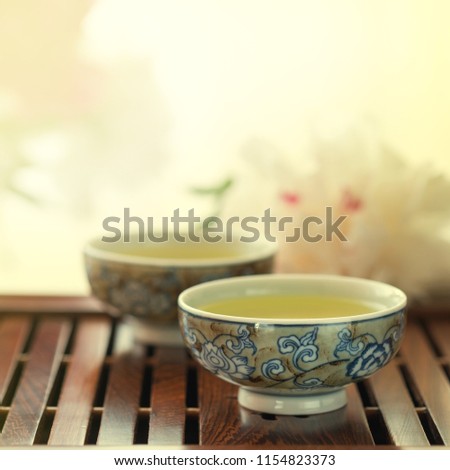 Traditional chinese tea ceremony Cun Fu Cha with two cups of green tea, toned