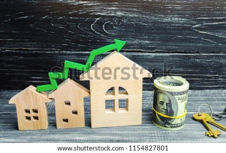 Wooden houses stand in a row from small to large with a green arrow up. concept of high demand for real estate. increase energy efficiency of housing. rise in house prices. property.