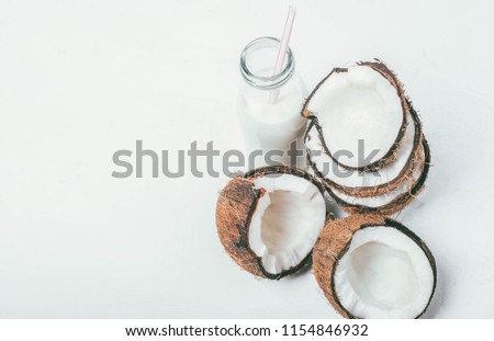 Fresh organic coconut milk in a tube bottle, coconut milkshake, place for text, white background