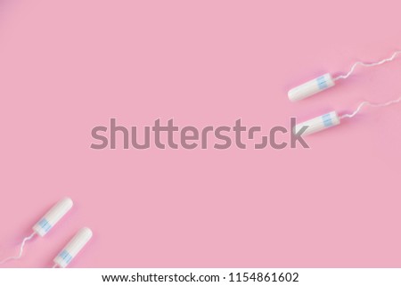 Menstrual tampon  on a pink background. Menstruation time. Hygiene and protection. Pasterl colors.