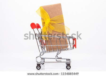 Small toy shopping cart on white background. Internet shopping concept.
