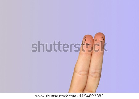 Finger art. Concept of a couple with funny expressions over blue background. Creative conceptual image of finger art, couple together, sad expressions.