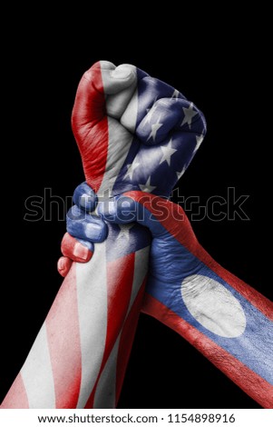 AMERICAN VS Laos, Fist painted in colors of Laos flag, fist flag, country of Laos