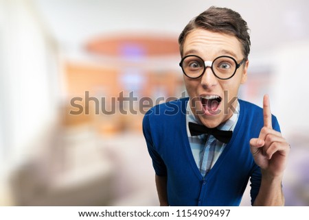 Young nerd man posing on background