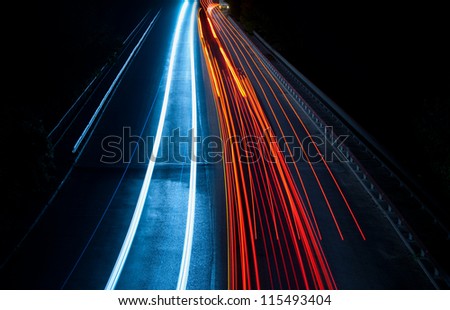 Abstract car lights in a tunnel in blue and red. Picture taken with long exposure