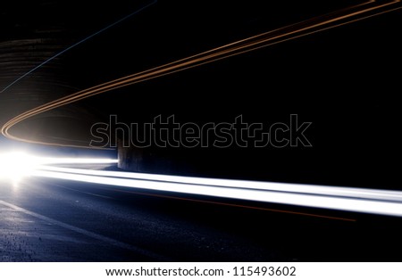 Abstract car lights in a tunnel in white. Picture taken with long exposure