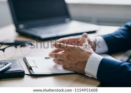  men's hands jacket jacket papers on the desk and laptop                              