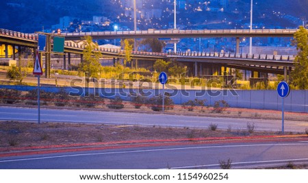 Light trails on Illuminated city motorway in evening 
