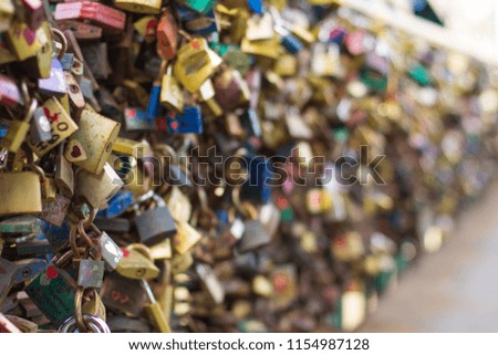 traditional romantic concept of many locks in bridge with unfocused bokeh colorful background