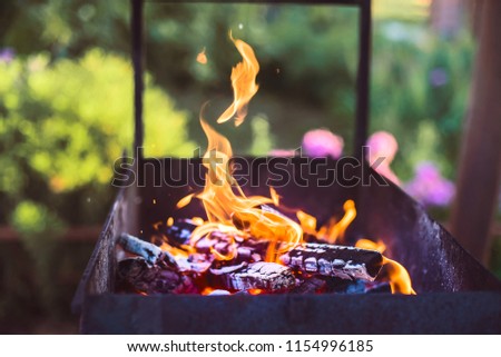 Fire in the grill on a warm summer day.
