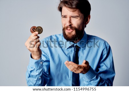 the man indignantly points to the coins                               