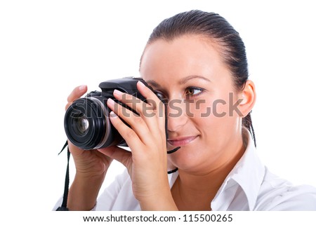 Brunette photographer woman holding camera over white background
