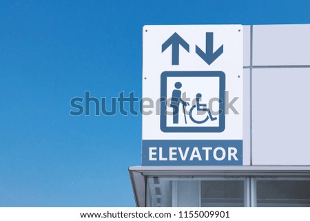 old man and handicap symbol with up and down arrow at elevator for disabled people in subway station