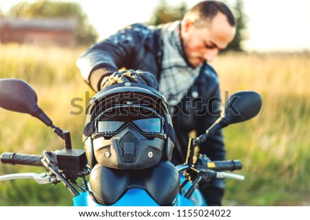 Biker on sport motorcycle outdoor on the road