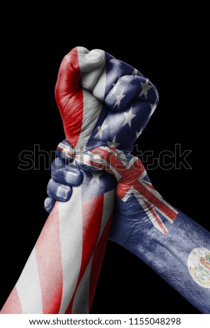 AMERICAN VS Cayman islands, Fist painted in colors of Cayman islands flag, fist flag, country of Cayman islands