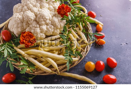 Beautiful picture of vegetables. Cherry tomatoes, cauliflower, and bean pods. Everything is grown on an organic farm