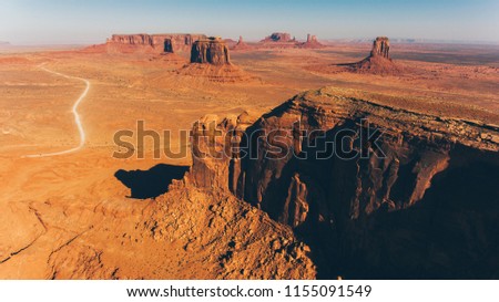 Bird's eye scenery view of unique geological formation of Arizona landmark. Monument Valley rocks one of the National symbols of the United States of America. Sandy desert landscape with mountains