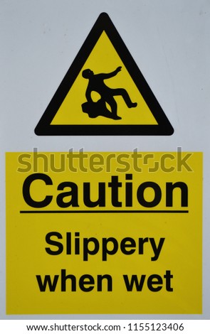 caution slippery when wet sign