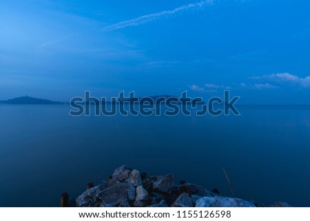 view of beach and sea water during the blue hour before sunrise
