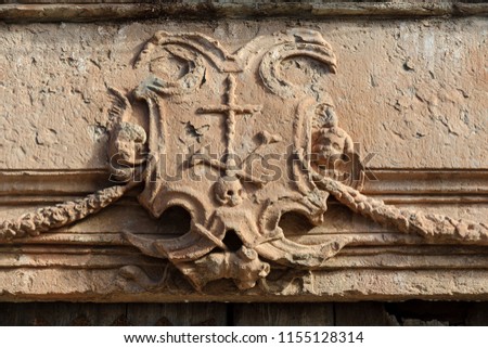 old coat of arms of the Spanish Inquisition in the town of Villanueva de Los Infantes, in Spain. Royalty-Free Stock Photo #1155128314