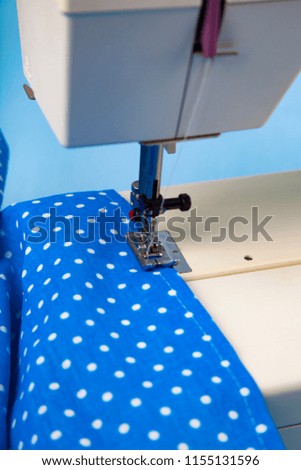 Sewing machine and blue fabric close-up