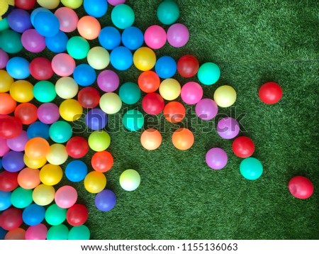 Colorful ball in playground with green background