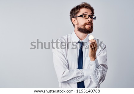 confident man with a coin in his hand                               