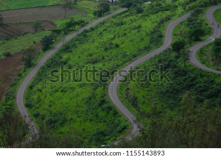 Road surrounded by Lush green monsoon nature landscape mountains, hills, India 