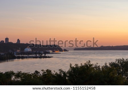 View at sunrise from the Sillery hill of the St. Lawrence River, a small marina, buildings, round silos and boats, Quebec City, Quebec, Canada Royalty-Free Stock Photo #1155152458