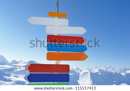 Arrow sign at mountains with snow in winter, Val-d'Isere, Alps, France