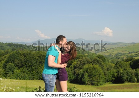 Young couple in love hug each other on the black background. Cuddling couple.  Love couple. Love hug. Love kiss. Couple kiss
