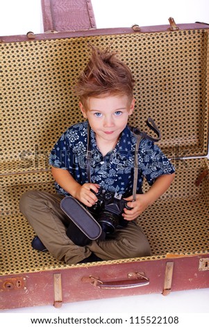 Portrait of young traveler posing in studio with camera