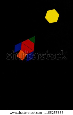 The space ship flies into space to another new planet. Summer happy atmosphere. A child plays with colored blocks constructs a model on a black background