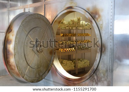 An open safe with gold and banknotes