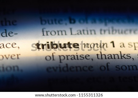 tribute word in a dictionary. tribute concept. Royalty-Free Stock Photo #1155311326