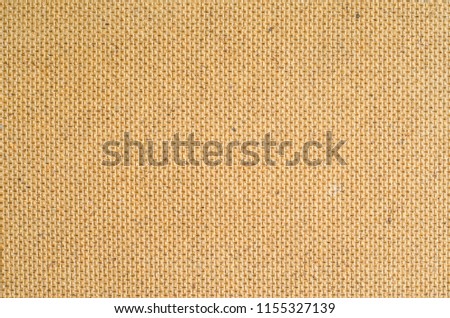 Wooden fiberboard texture. Rear side of the material with regular pattern of embossing. Close-up abstract background of construction material.