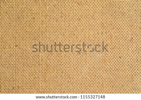 Wooden fiberboard texture. Rear side of the material with regular pattern of embossing. Close-up abstract background of construction material.