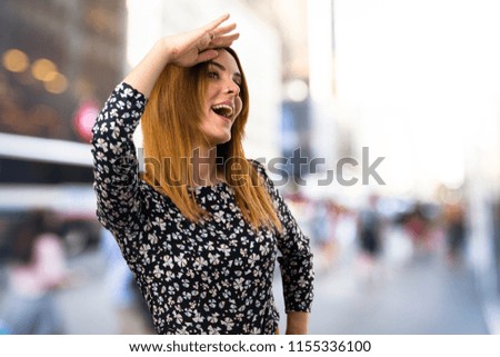 Beautiful young girl saluting on unfocused background